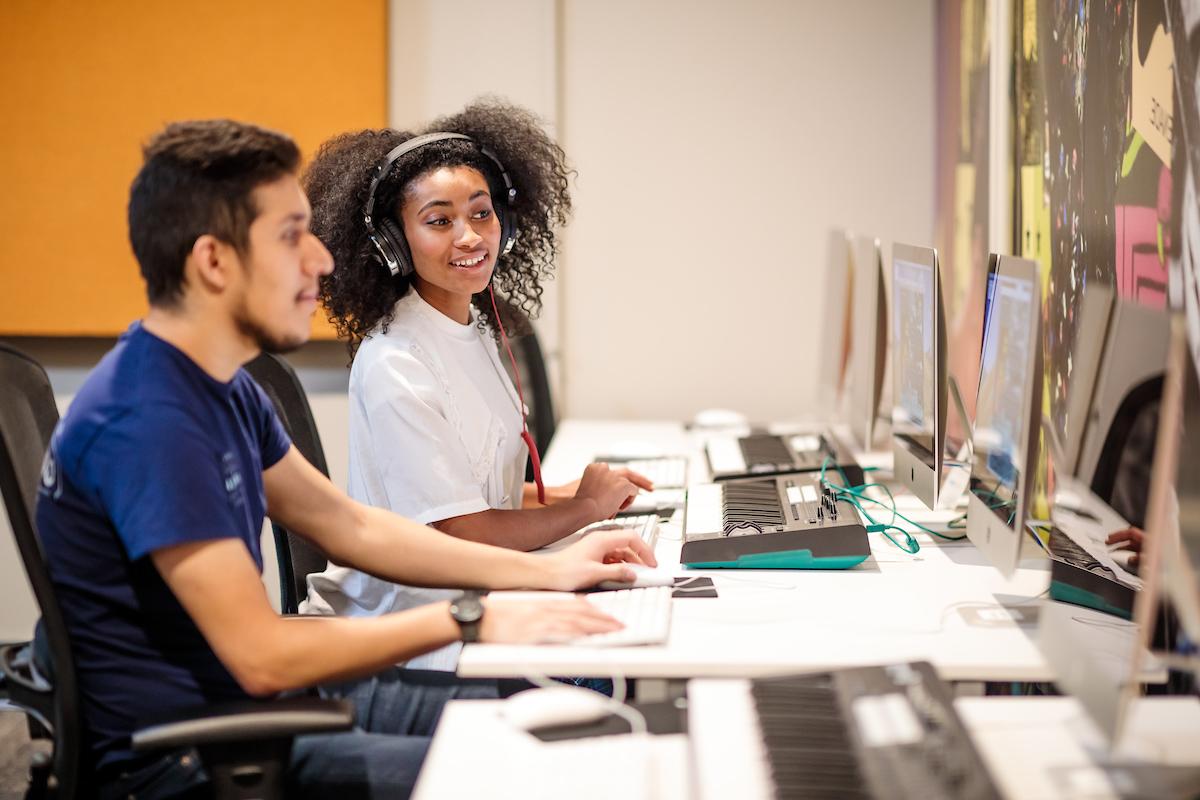 Students studying together at a computer lab.