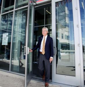 MSU Denver President Stephen Jordan stepping through doors
