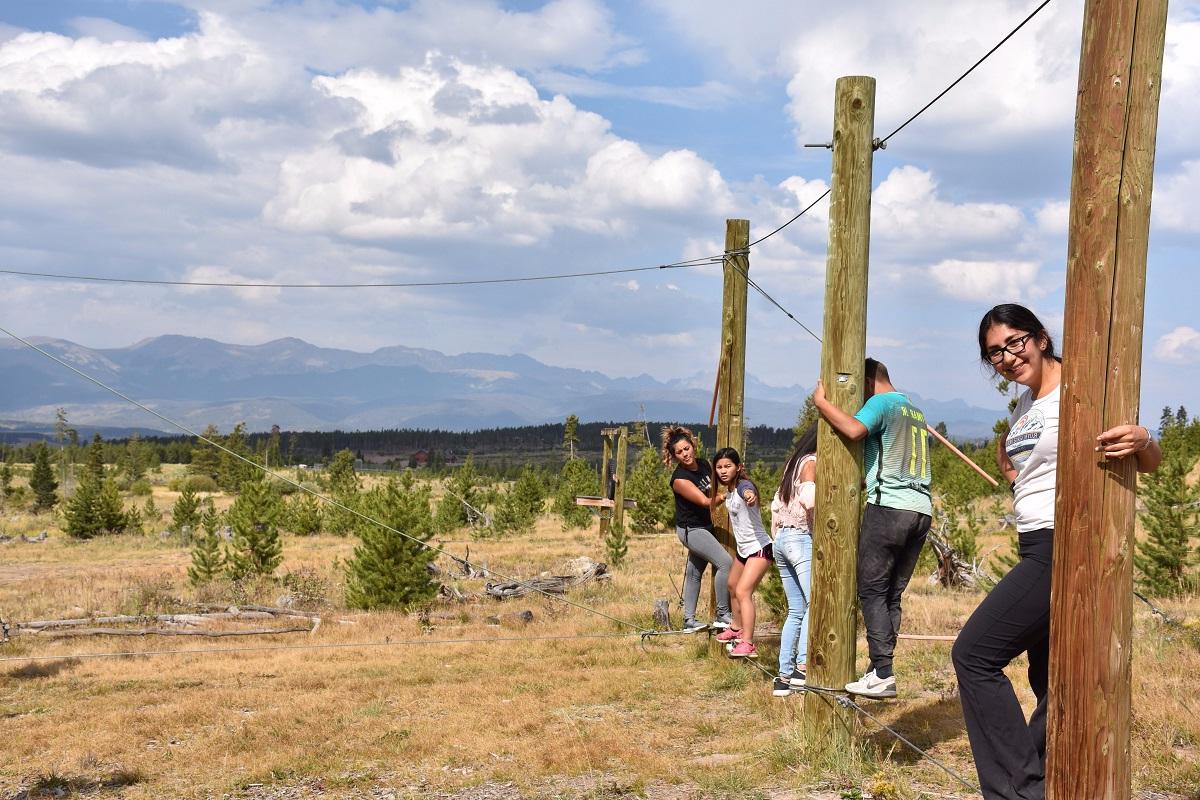 CAMP students doing a ropes course on retreat