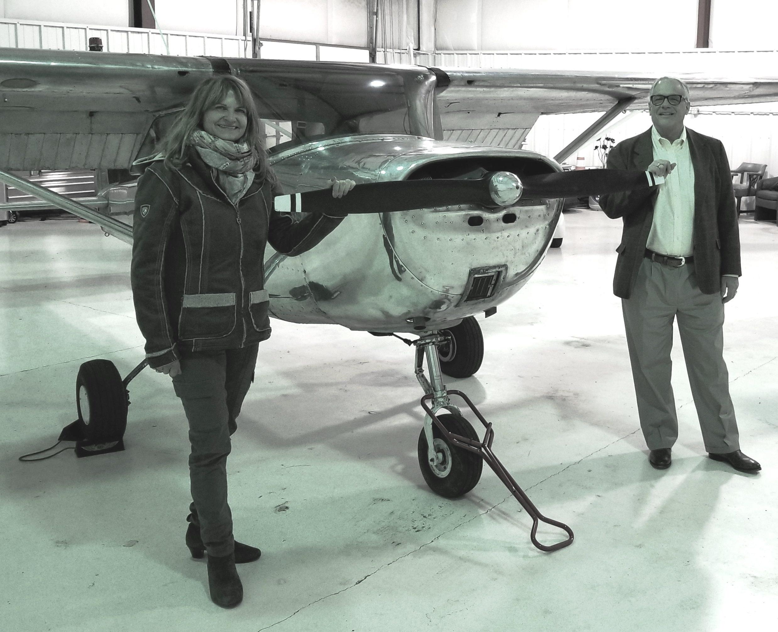 Department Chair Dr. Jeffrey Forrest and Faculty member Dagmar Kress stand by a single-engine airplane.